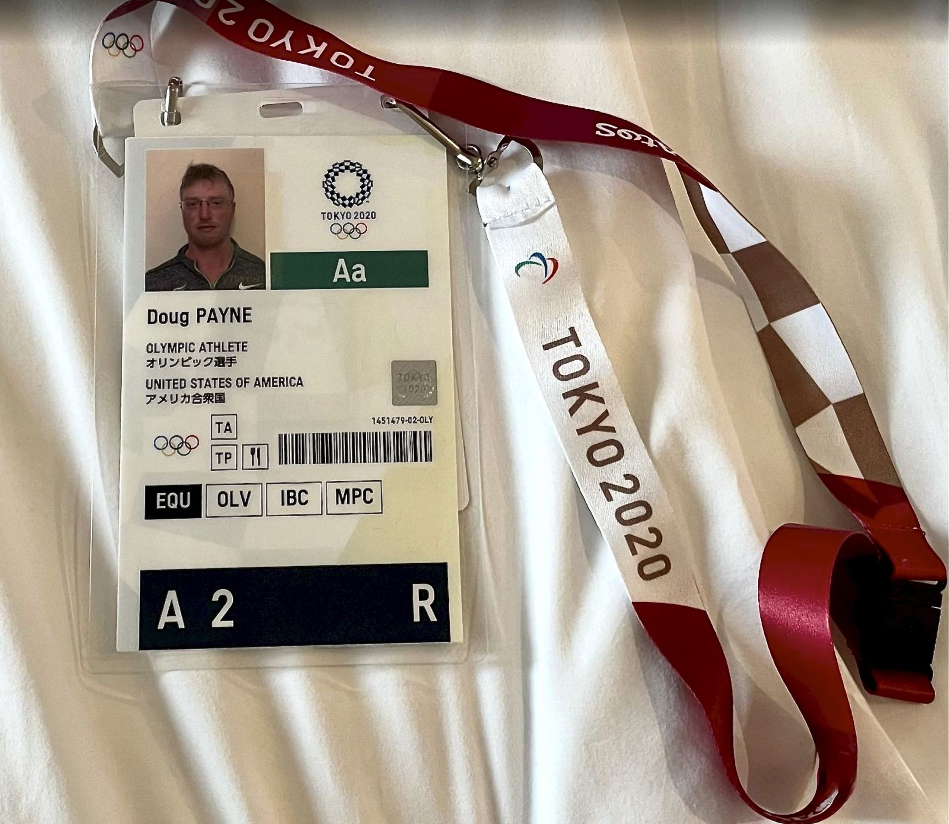 Olympic athlete identification card for Doug Payne, displaying name, nationality, and event details from the Tokyo 2020 Olympics.