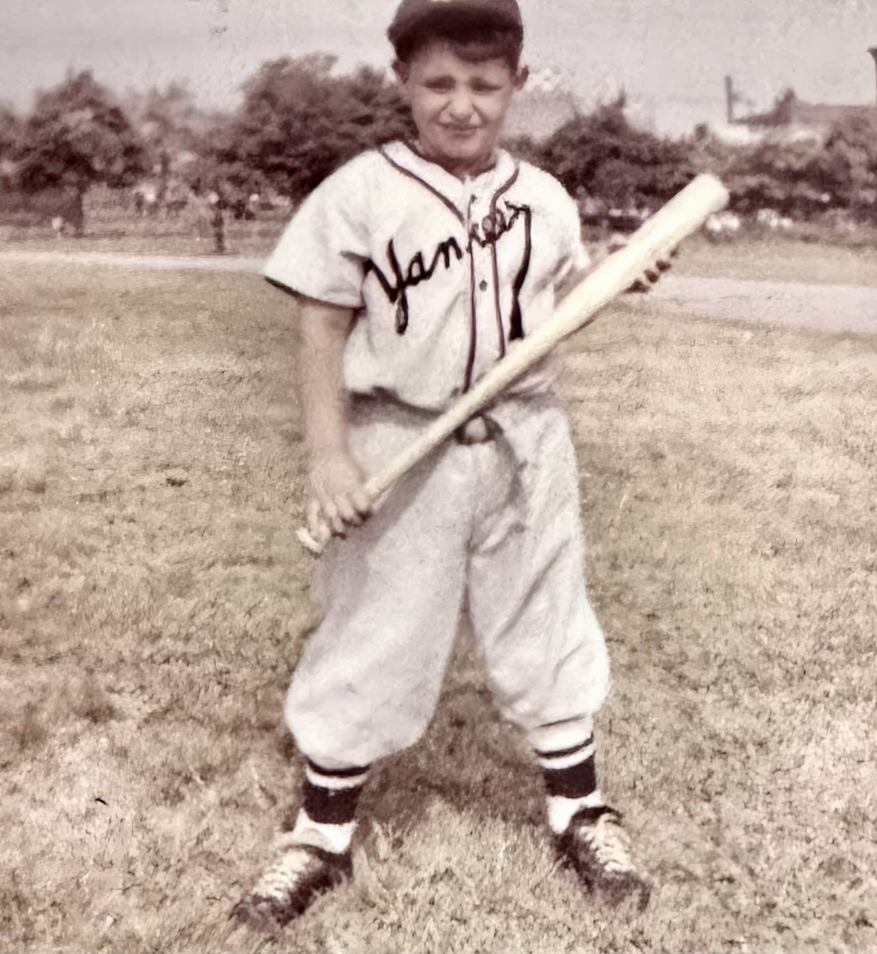 Dom Scala as a boy in a Yankees shirt holding a baseball bat